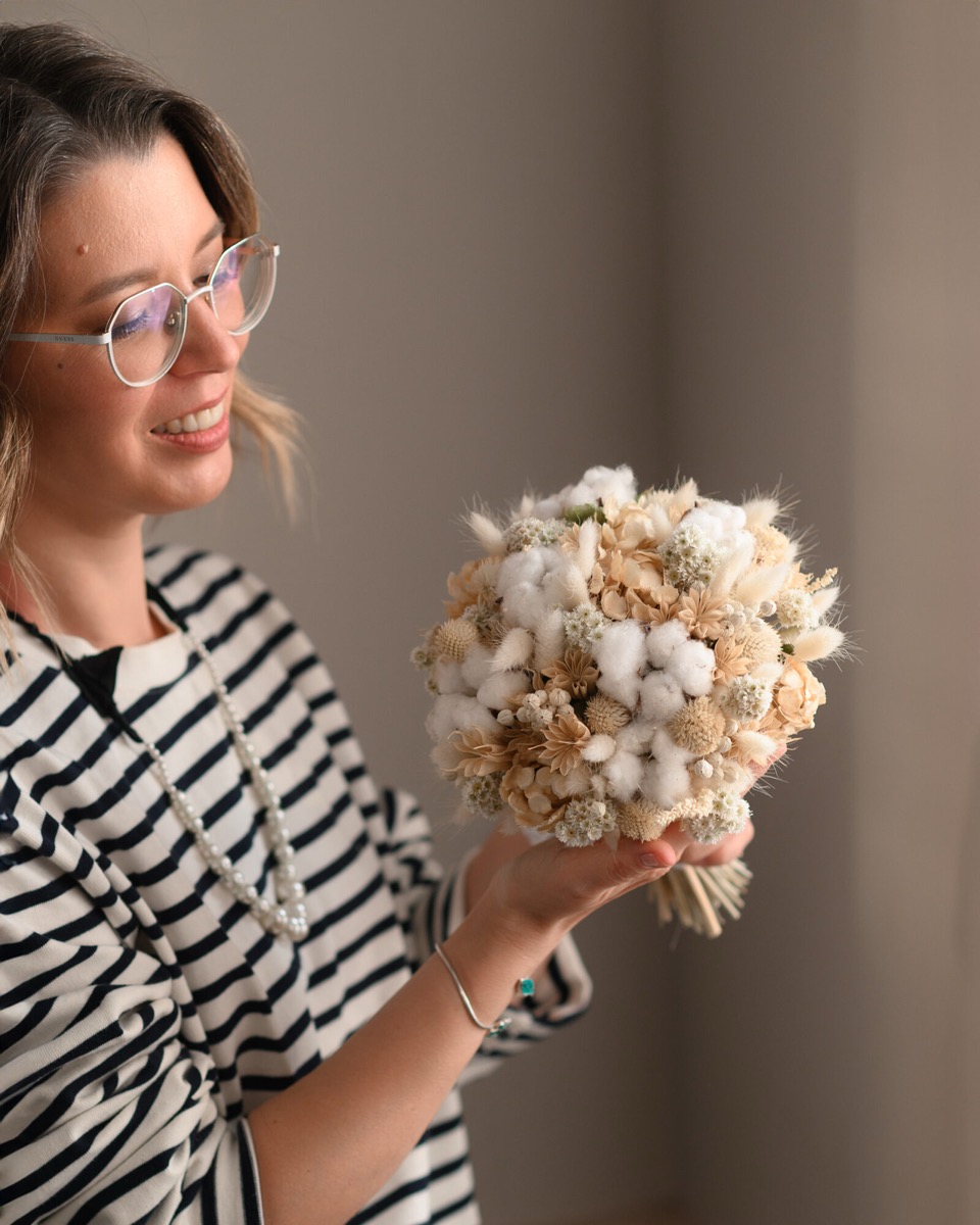 Glass cloche with dried flowers — held by instructor during class