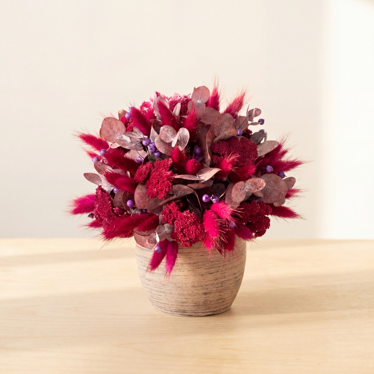 Elegant dried flower bouquet with white roses, pampas feathers and lagurus — held by hand, studio photo